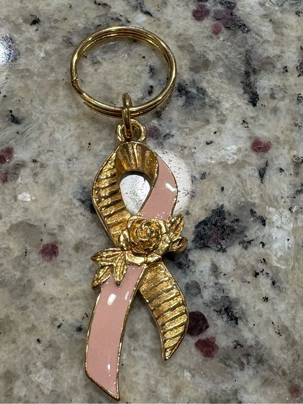 Avon pink enameled gold tone with rose key chain in very good condition
